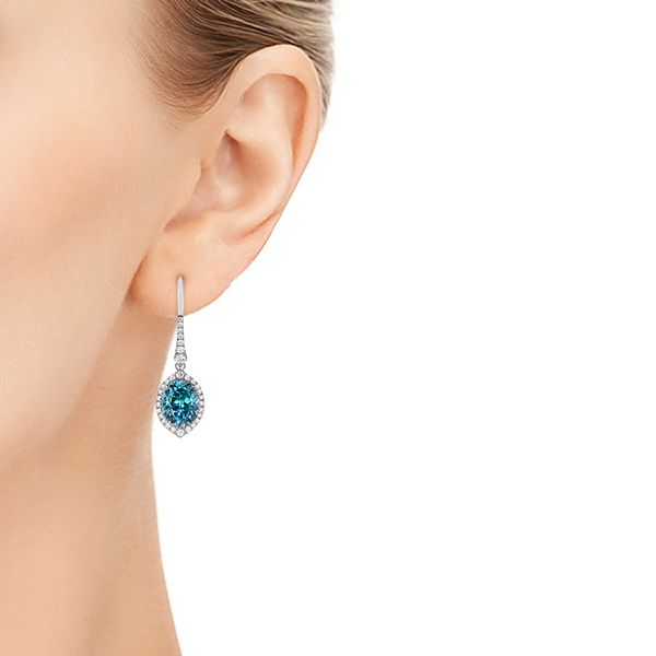 14k White Gold Blue Topaz And Diamond Halo Earrings - Hand View - 106047