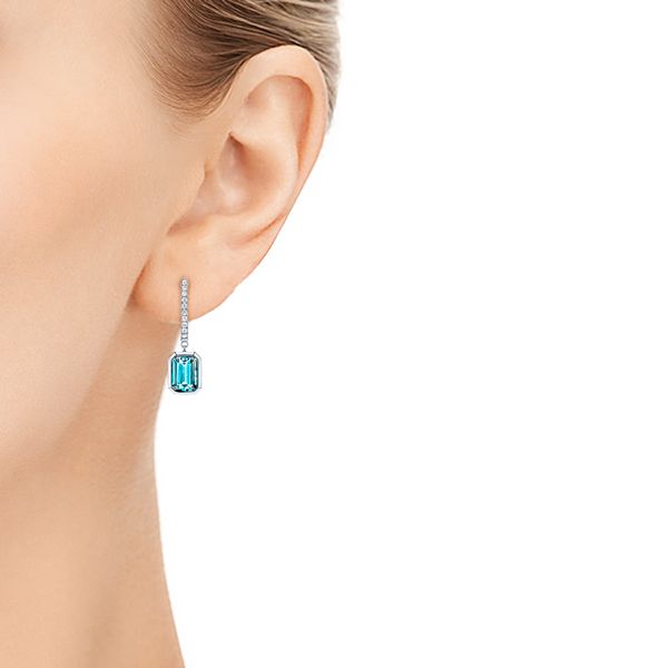  Platinum Platinum Blue Topaz And Diamond Huggie Earrings - Hand View -  106550