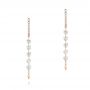 18k Rose Gold 18k Rose Gold Floating Diamond Huggie Earrings - Three-Quarter View -  106993 - Thumbnail