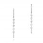  Platinum Platinum Floating Diamond Huggie Earrings - Three-Quarter View -  106993 - Thumbnail