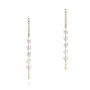 18k Yellow Gold 18k Yellow Gold Floating Diamond Huggie Earrings - Three-Quarter View -  106993 - Thumbnail