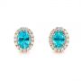 14k Rose Gold 14k Rose Gold Oval Blue Zircon And Diamond Halo Earrings - Three-Quarter View -  105010 - Thumbnail