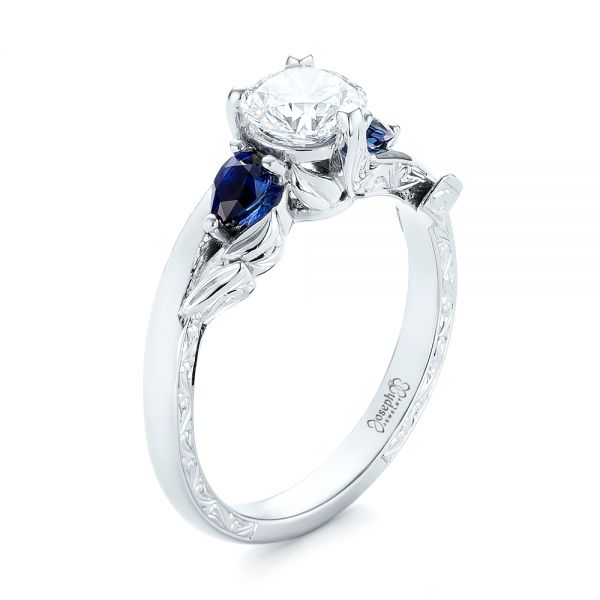 18k White Gold 18k White Gold Custom Three Stone Blue Sapphire And Diamond Hand Engraved Engagement Ring - Three-Quarter View -  103488